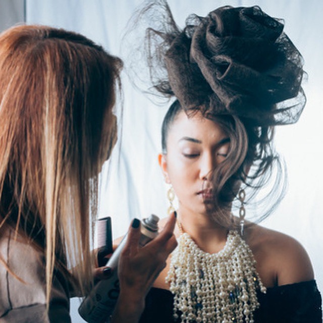 Bridal Hair Toronto stylist finishing up an abstract hairstyle